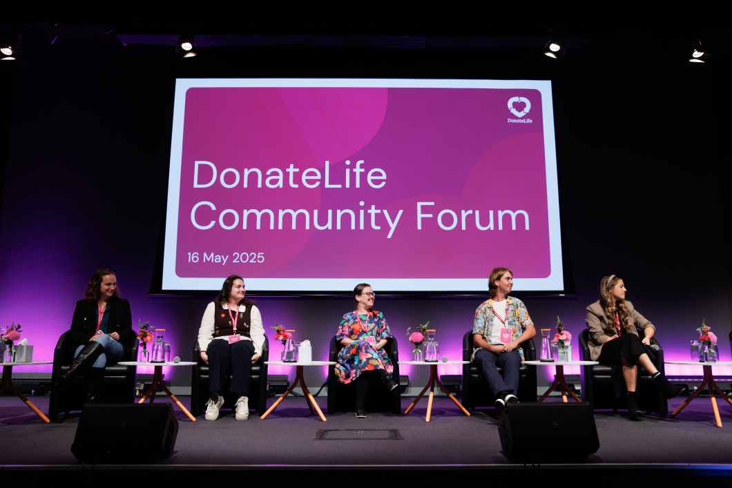 Panelists at the DonateLife Community Forum on May 16, 2025, seated with floral arrangements and a large presentation screen.