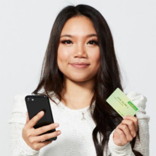 Transplant recipient Kristy holding a Medicare card and phone 