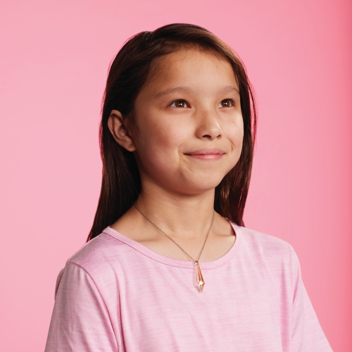 Sunny pictured in front of a pink backdrop