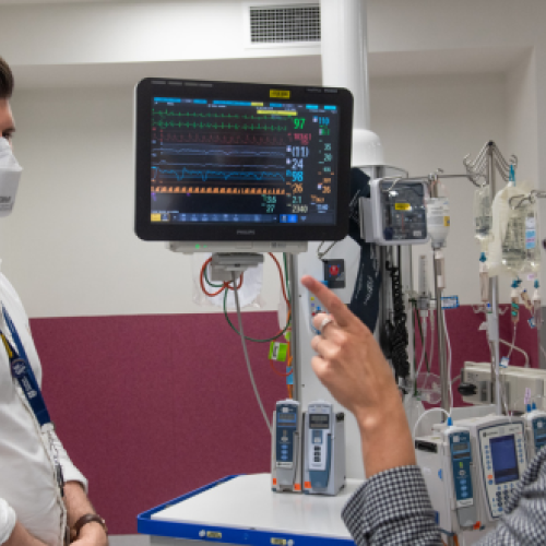 Two people standing in a hospital setting